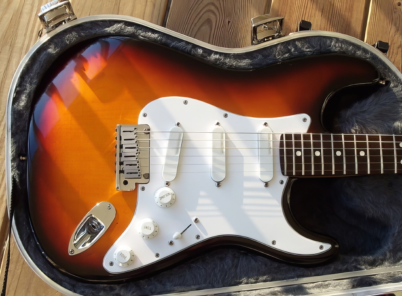 1993 Fender Stratocaster Plus — body in case, sunburst finish, white pickguard, Lace Sensor pickups
