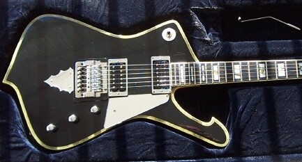 1979 Ibanez Iceman PS-10 — black body in case, cream binding, chrome pickups and cloud tailpiece